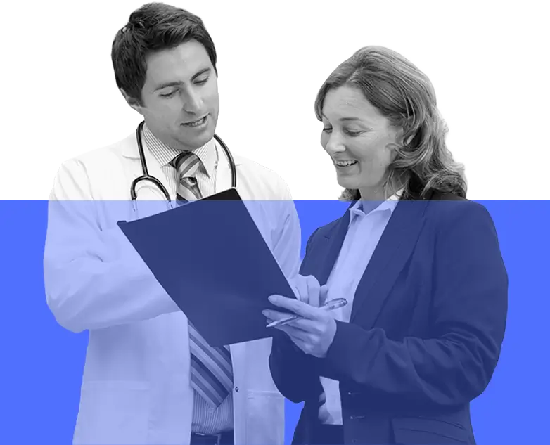 A doctor and a woman examine a folder together, discussing its contents in a professional setting.